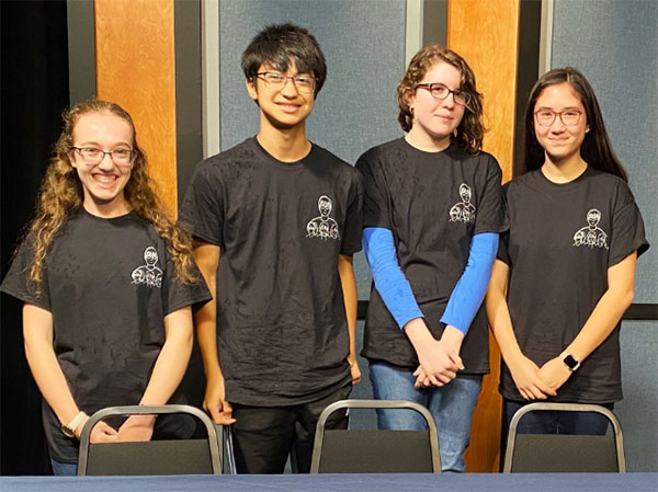 2020 Battle of the HS winners; four students standing behind a table.